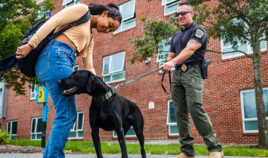 Ryan Tepper with K-9 Zach and a student 